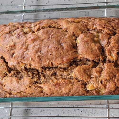 pan of hearty whole wheat banana bread on cooling rack