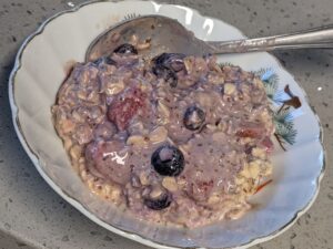 bowl of peanut butter overnight oats using frozen fruit