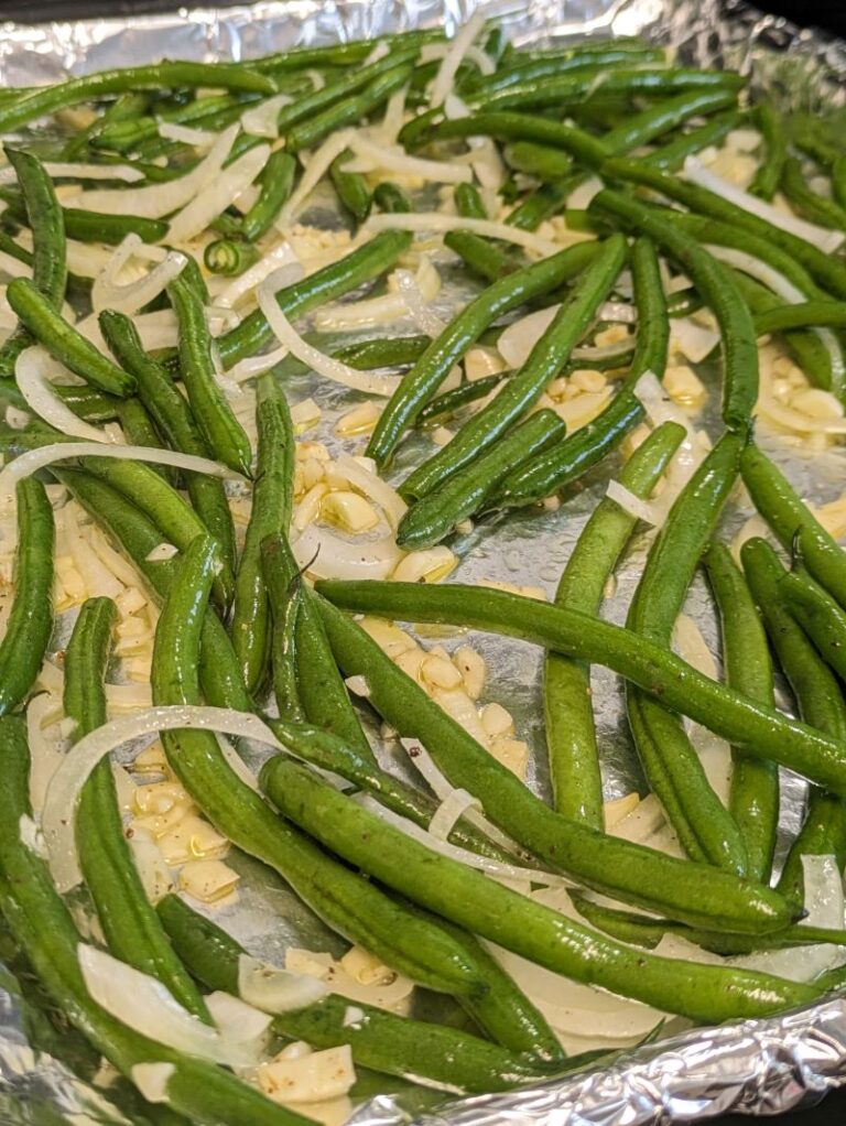 green beans on a baking sheet before roasting