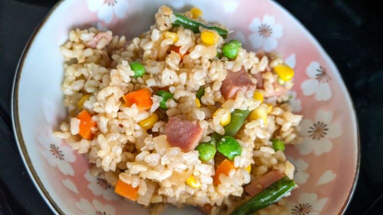 garlic fried rice with spam, vegetables, and brown rice in a bowl