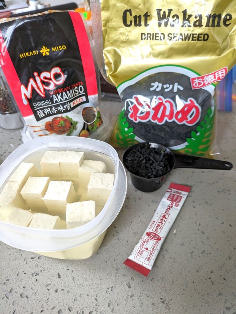 bowl of tofu cubes with miso soup ingredients