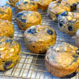 moistest blueberry banana muffins on cooling rack