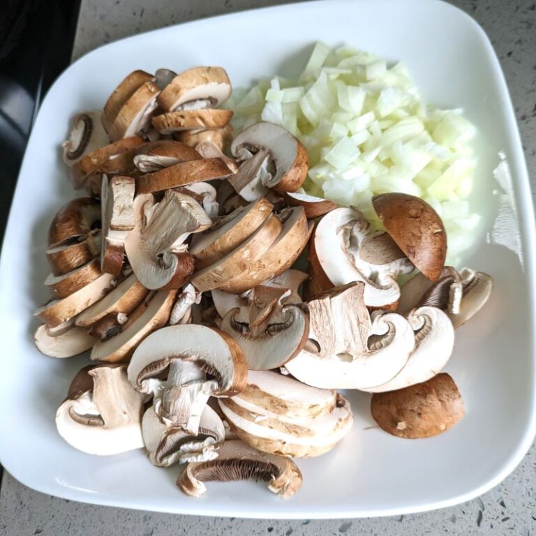 sliced mushrooms and chopped onions on a plate