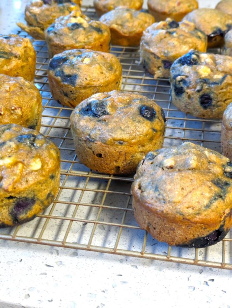 moistest blueberry banana muffins on a cooling rack