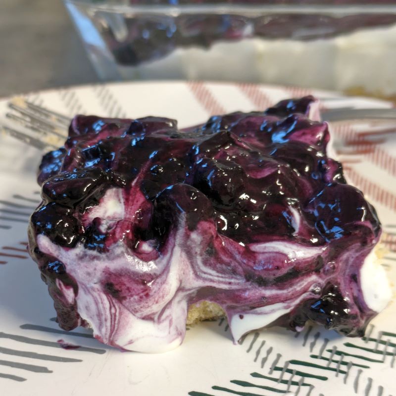 slice of blueberry cream cheese pie on a plate