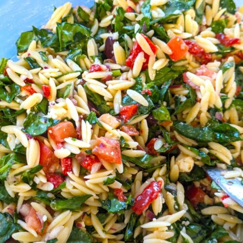 spinach orzo salad in a bowl without cumbers