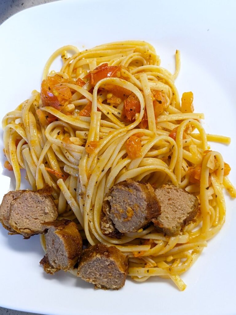 fresh roma tomato pasta sauce on a plate with sausage