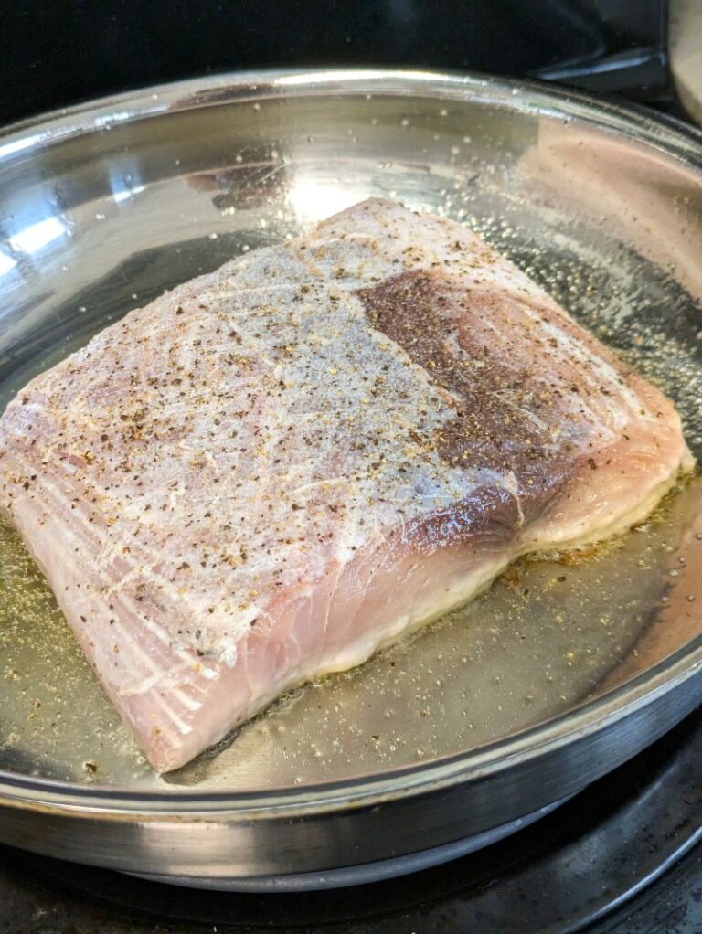 mahi mahi fillet being seared in a pan