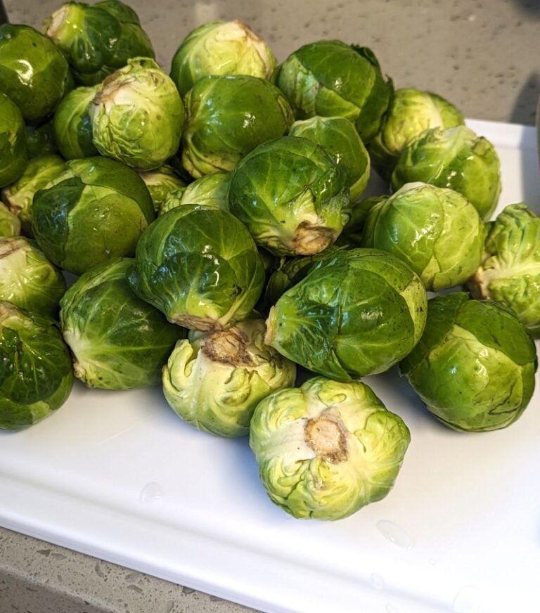 a pile of brussel sprouts on a cutting board